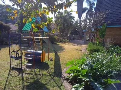 a playground in a yard with a play structure at Ratel Street Guesthouse in Pretoria