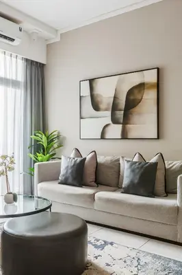 a living room with a couch and a table at The Menlyn Main Residents Trilogy in Pretoria