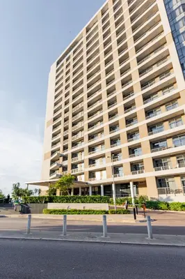 a large building with a street in front of it at The Menlyn Main Residents Trilogy in Pretoria