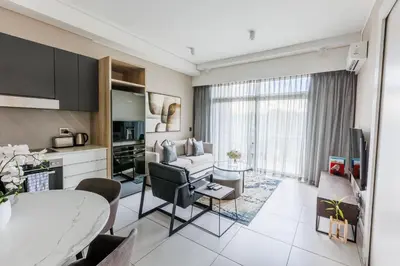 a living room with a couch and a table at The Menlyn Main Residents Trilogy in Pretoria