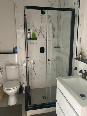 a bathroom with a shower and a toilet and a sink at Spectacular 2 bedroom Penthouse Apartment in Midrand