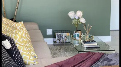 a living room with a couch and a glass table at Spectacular 2 bedroom Penthouse Apartment in Midrand