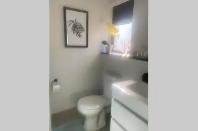 a bathroom with a white toilet and a sink at Spectacular 2 bedroom Penthouse Apartment in Midrand