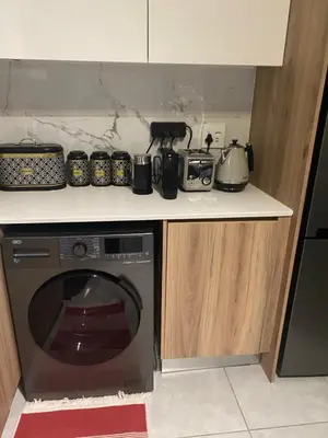 a kitchen counter with a dishwasher and pots and pans at Spectacular 2 bedroom Penthouse Apartment in Midrand