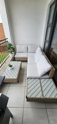 a living room with two couches on a balcony at The Blyde Beach View in Pretoria