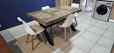 a wooden table with white chairs and a washing machine at The Blyde Beach View in Pretoria