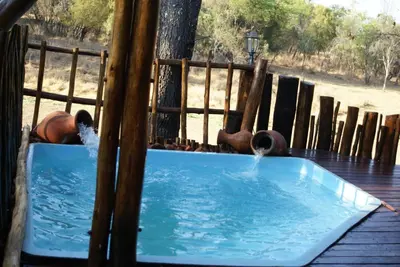 a hot tub with water coming out of it at Beka Idube Bushveld Retreat in Cullinan