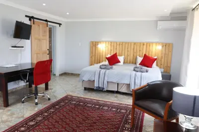 a bedroom with a bed and a desk and a bed sidx sidx sidx at 7 At Brainline in Pretoria