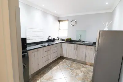 a kitchen with a sink and a refrigerator at 7 At Brainline in Pretoria