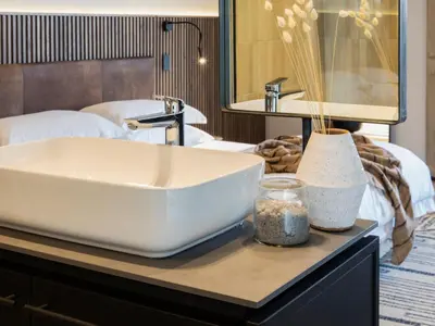 a bathroom with a white sink on a table at Askara Haus in Pretoria
