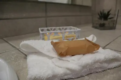 a pile of white towels sitting on a bathroom floor at Lindekroon Guest House in Polokwane