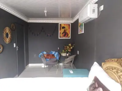 a room with a bed and a chair in it at BEULAH GROUP BnB in Malamulele