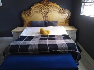 a bedroom with a bed with a yellow stuffed animal on it at BEULAH GROUP BnB in Malamulele