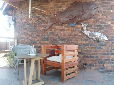 a brick wall with a table and a fish on it at BEULAH GROUP BnB in Malamulele