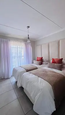 a bedroom with two beds and a large window at The Blyde in Pretoria