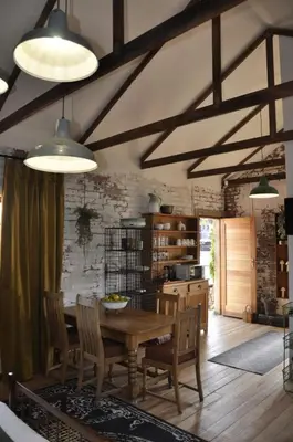 a dining room with a wooden table and chairs at SOUSIE'S RUSTIC STAY in Polokwane