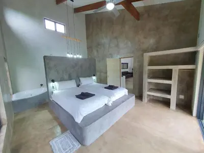 a bedroom with a large bed and a bath tub at Lionsview Private Lodge - 4 Lions in Marloth Park