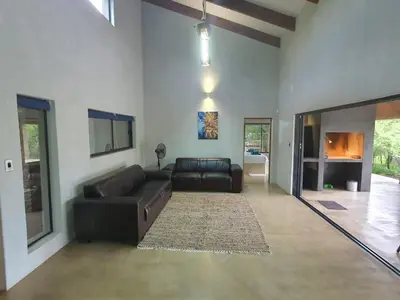 a living room with a leather couch and a fireplace at Lionsview Private Lodge - 4 Lions in Marloth Park