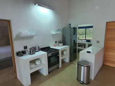 a kitchen with white counters and a stove top oven at Lionsview Private Lodge - 4 Lions in Marloth Park