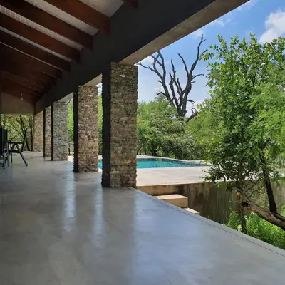 an outdoor patio with a view of a swimming pool at Lionsview Private Lodge - 4 Lions in Marloth Park