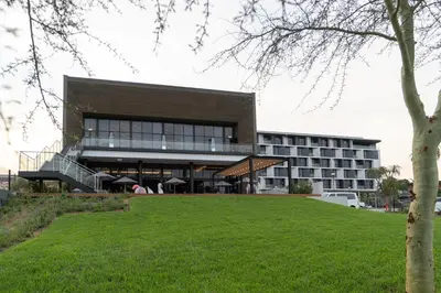 a large building with a green lawn in front of it at The Capital Mbombela in Nelspruit