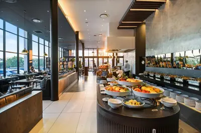 a buffet line with bowls of food in a restaurant at The Capital Mbombela in Nelspruit