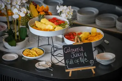 a buffet with bowls of fruit and vegetables on a table at The Capital Mbombela in Nelspruit