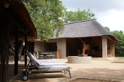 a bench in front of a building with a roof at 86 Zebula 10 Sleeper Lodge in Mabula