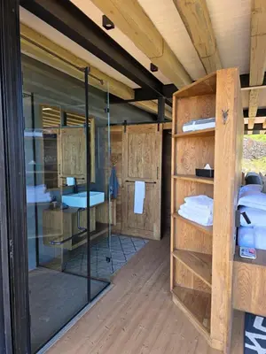 a room with several bunk beds and glass doors at Eagle View on Beumont in Dullstroom