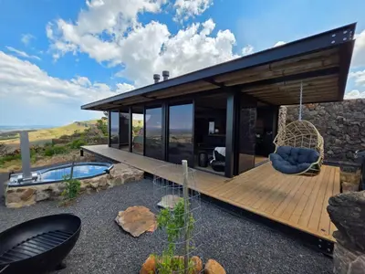 a house with a deck with a swing at Eagle View on Beumont in Dullstroom