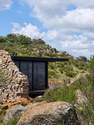 a glass house on top of a rocky hill at Eagle View on Beumont in Dullstroom
