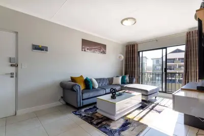 a living room with a couch and a table at #AlimamaSpaces: The Hakings Luxury Place in Midrand
