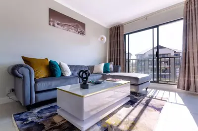 a living room with a couch and a coffee table at #AlimamaSpaces: The Hakings Luxury Place in Midrand