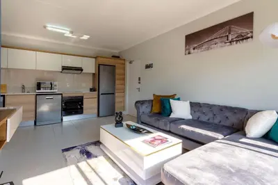 a living room with a couch and a table at #AlimamaSpaces: The Hakings Luxury Place in Midrand