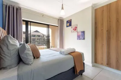 a bedroom with a bed with a large window at #AlimamaSpaces: The Hakings Luxury Place in Midrand