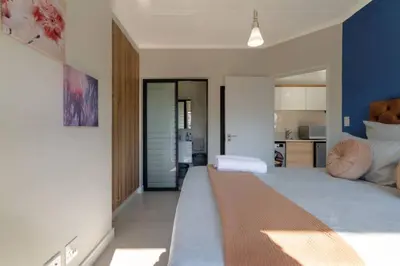 a large bedroom with a large bed and a kitchen at #AlimamaSpaces: The Hakings Luxury Place in Midrand