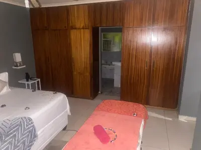 a hotel room with a bed and a bathroom at Warmbaths Thai Spa and Guest House in Bela-Bela