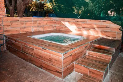 a hot tub built into a brick wall at Warmbaths Thai Spa and Guest House in Bela-Bela