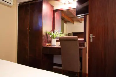 a bedroom with a bed and a desk with a plant at Zoete Rust Boutique Hotel in Lephalale