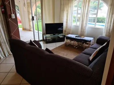 a living room with two couches and a tv at Kosmos View Luxury Apartments in Hartbeespoort