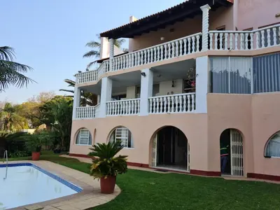 a building with a swimming pool in front of it at Kosmos View Luxury Apartments in Hartbeespoort