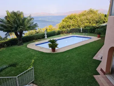 a swimming pool in the yard of a house at Kosmos View Luxury Apartments in Hartbeespoort