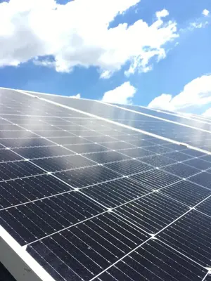 a group of solar panels against a blue sky at Olive Branch Cottage off grid in Benoni
