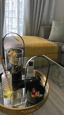 a coffee table with a cell phone on top of it at Ellipse Waterfall Luxury Sapphire in Midrand