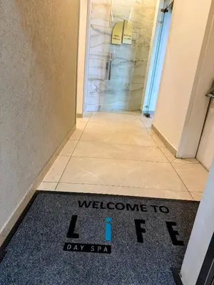 a welcome to a day spa sign on a bathroom floor at Ellipse Waterfall Luxury Sapphire in Midrand