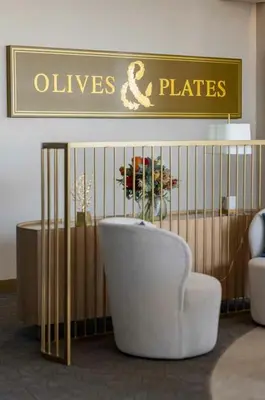 a room with a crib and a couch and a chair at Ellipse Waterfall Luxury Sapphire in Midrand