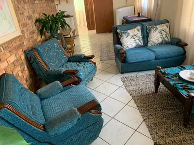 a living room with two chairs and a couch at Cottage 32 in Groblersdal