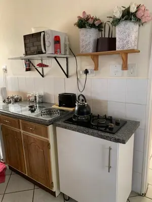a small kitchen with a stove and a counter top at Cottage 32 in Groblersdal