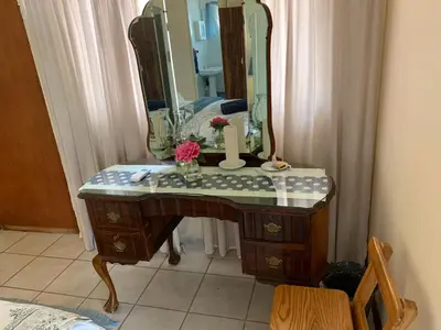 a bathroom with a vanity with a mirror and a sink at Cottage 32 in Groblersdal
