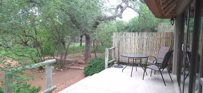 a patio with a table and chairs on a porch at Amukela Kaya in Hoedspruit
